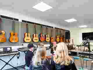 Pupils in music room with suspended acoustic ceiling.