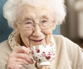 Old woman having tea